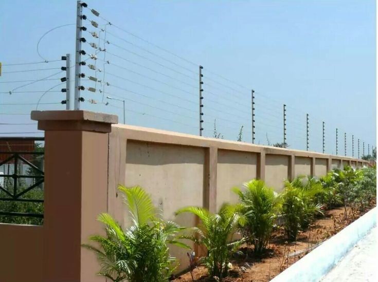 Electric fence along a wall